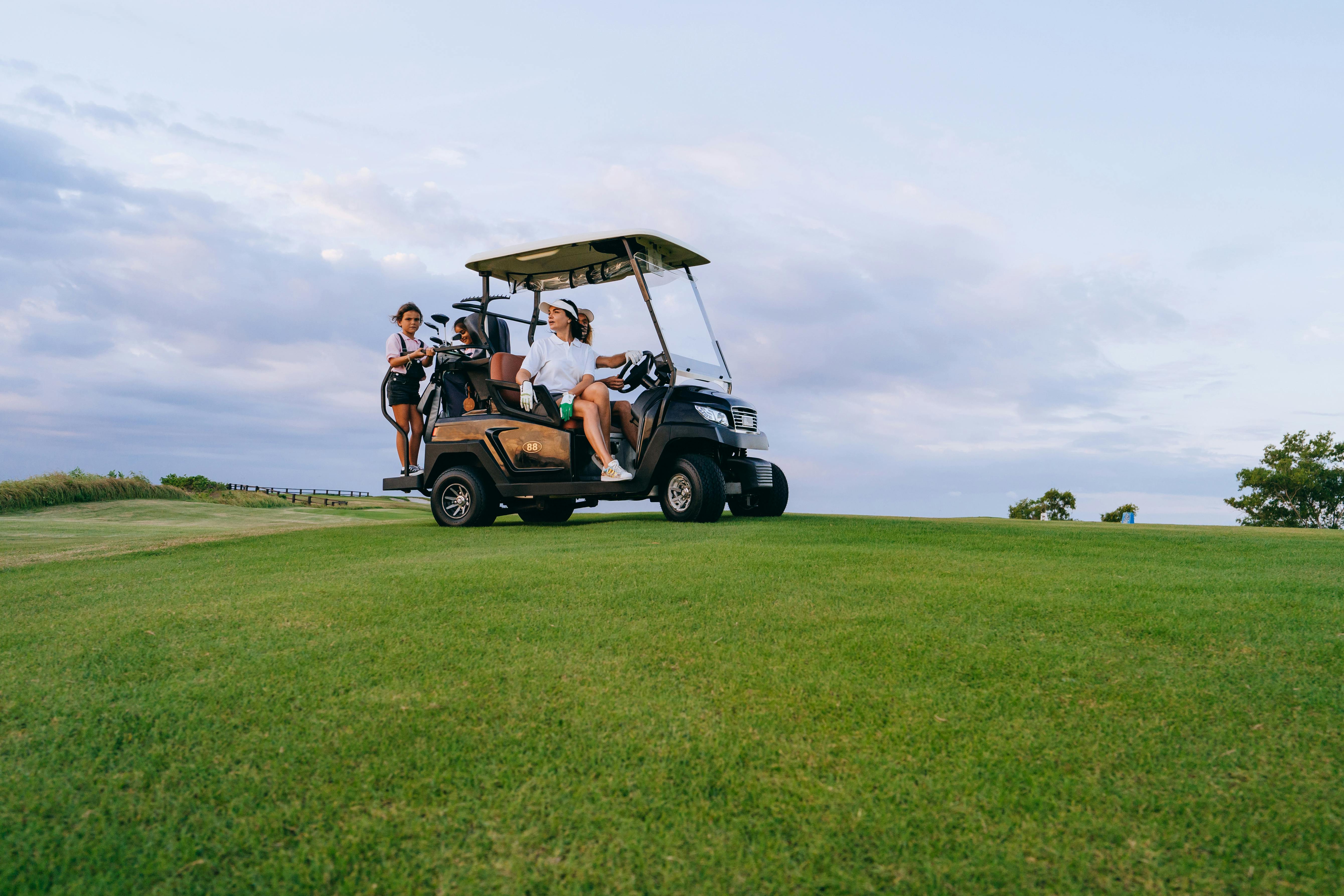 golfers on golf cart